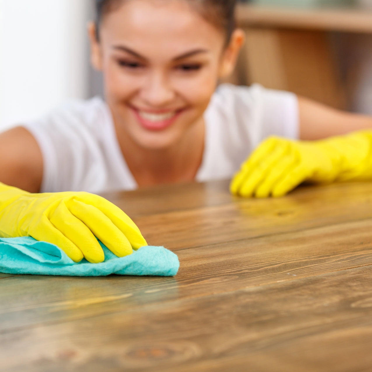 Woman cleaning a wood surface in preparation to use Retique It and transform it